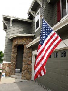 Stone front entrance to home with American flag